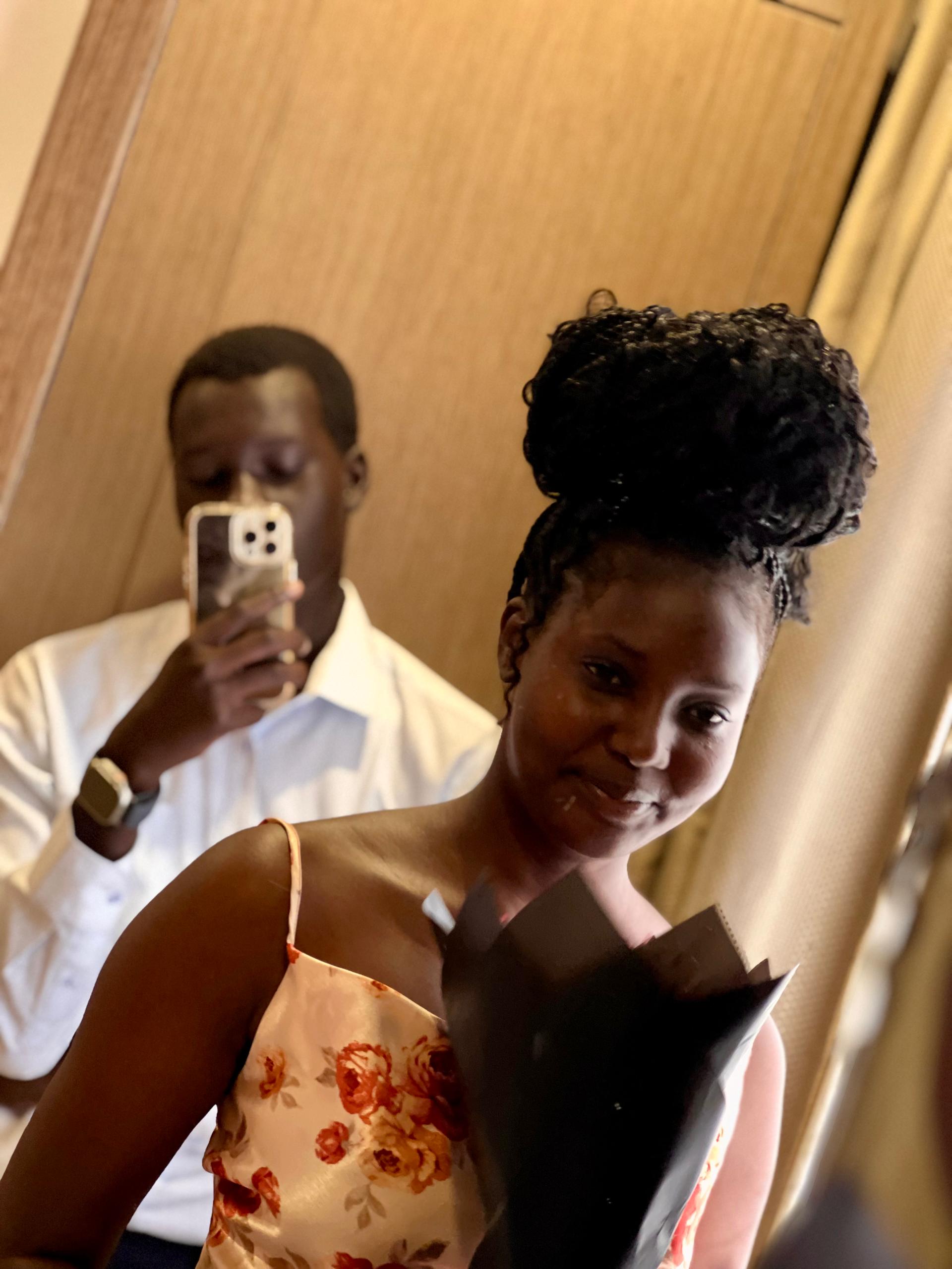 Professional African couple in business attire smiling confidently in modern office setting