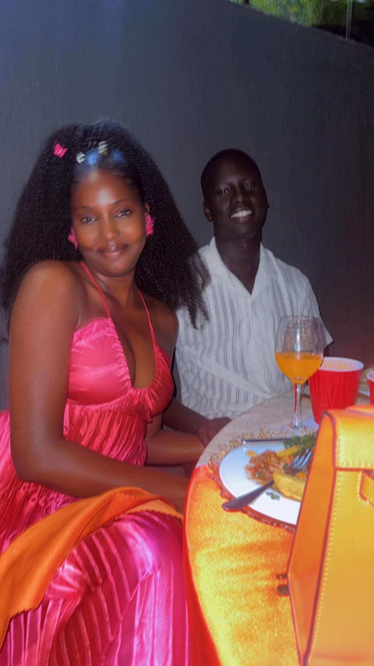 Middle-aged African couple in traditional South Sudanese attire standing together outdoors